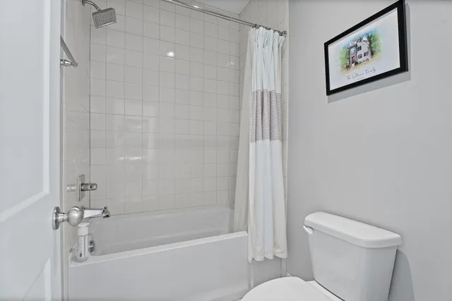a white bath tub sitting next to a white toilet