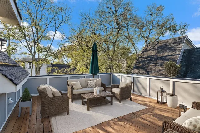 a balcony with wooden floor and furniture