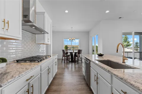 a kitchen with granite countertop a sink and stove