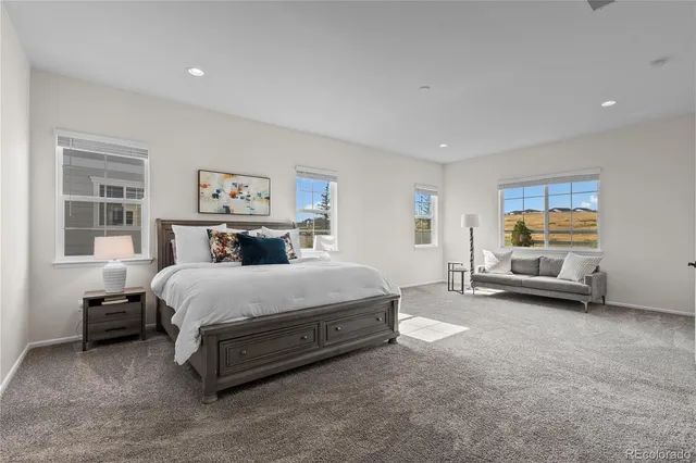 a spacious bedroom with a bed and a large window