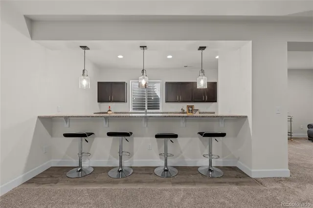 a kitchen with stainless steel appliances kitchen island granite countertop a sink and a microwave