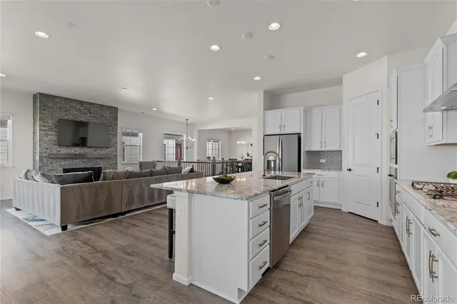 a kitchen with stainless steel appliances a sink and a stove top oven