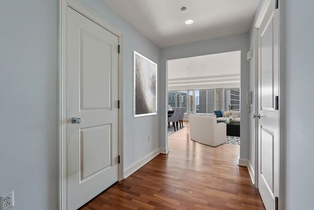 a view of a living room with furniture and wooden floor