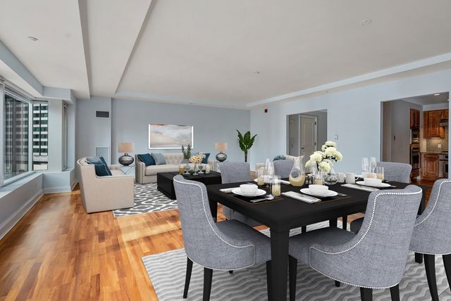 a living room with furniture a table and a potted plant