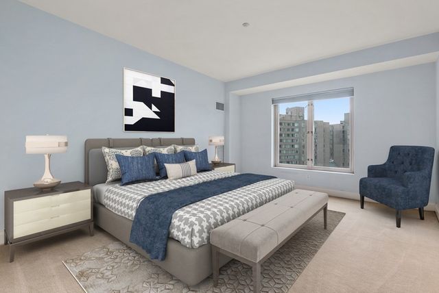 a bedroom with bed and a chair