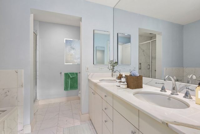 a bathroom with a double vanity sink mirror and double
