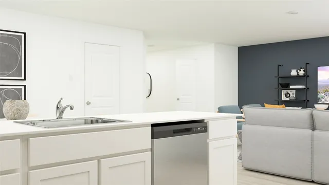 a room with a sink cabinets and appliances