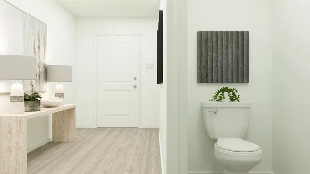 a bathroom with a toilet a sink and mirror