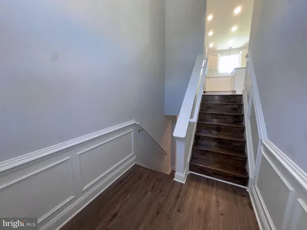 a view of entryway with stairs and wooden floor