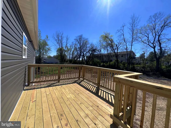a view of balcony with wooden floor and fence