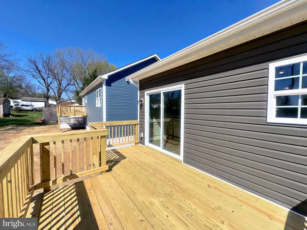 a view of a house with wooden deck