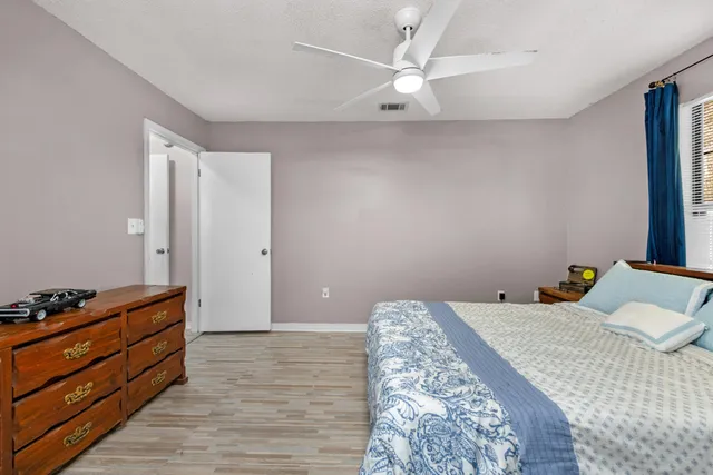 a bedroom with a bed and a dresser