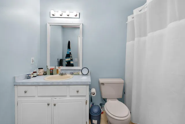 a bathroom with a sink a toilet and mirror