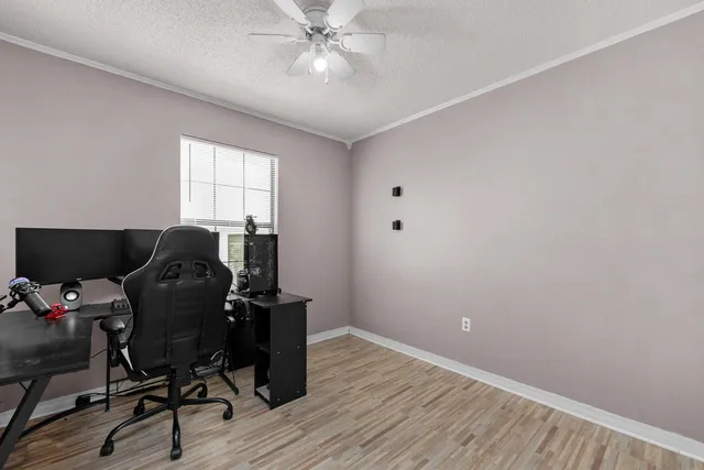 a view of workspace with wooden floor windows