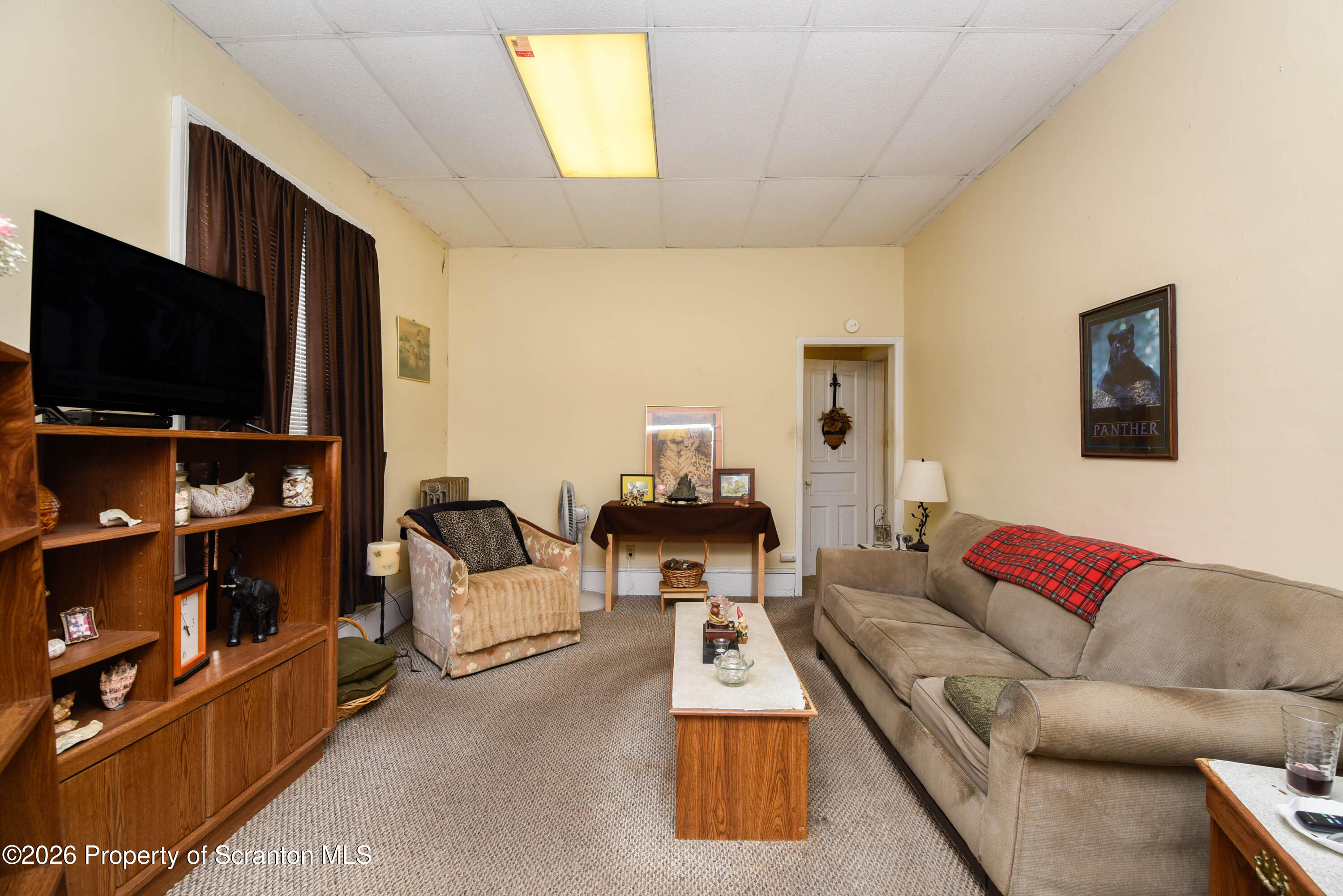 520 Main Street Archbald, PA 18403 - Photo 13 of 47 a living room with furniture and a flat screen tv