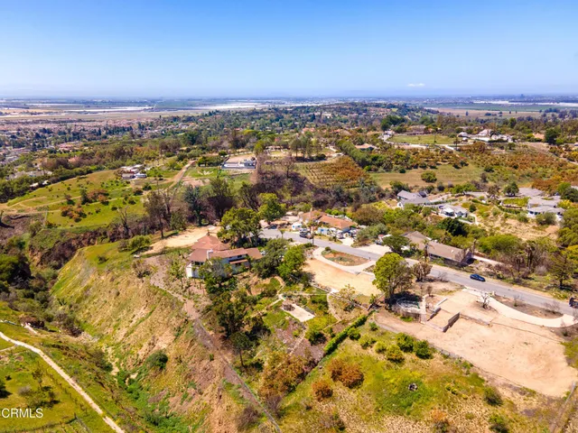 an aerial view of residential houses with city view