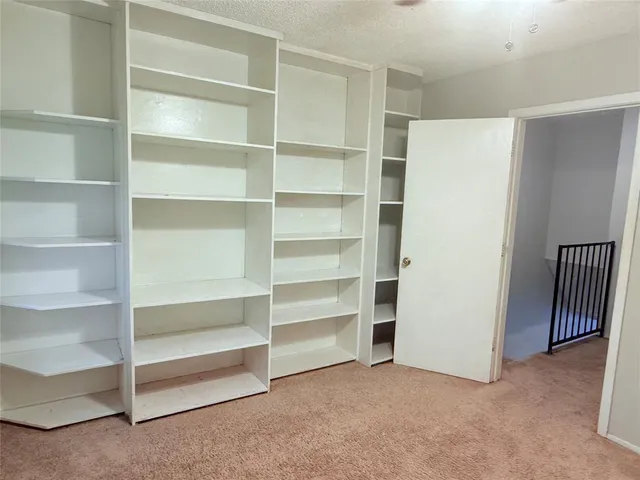 a view of an empty room with empty shelves