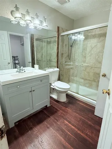 a bathroom with a sink toilet a mirror and shower