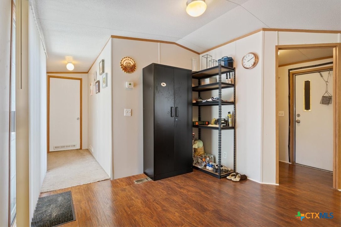 216 Moore Street Rogers, TX 76569 - Photo 11 of 29 a view of a big room with wooden floor and closet