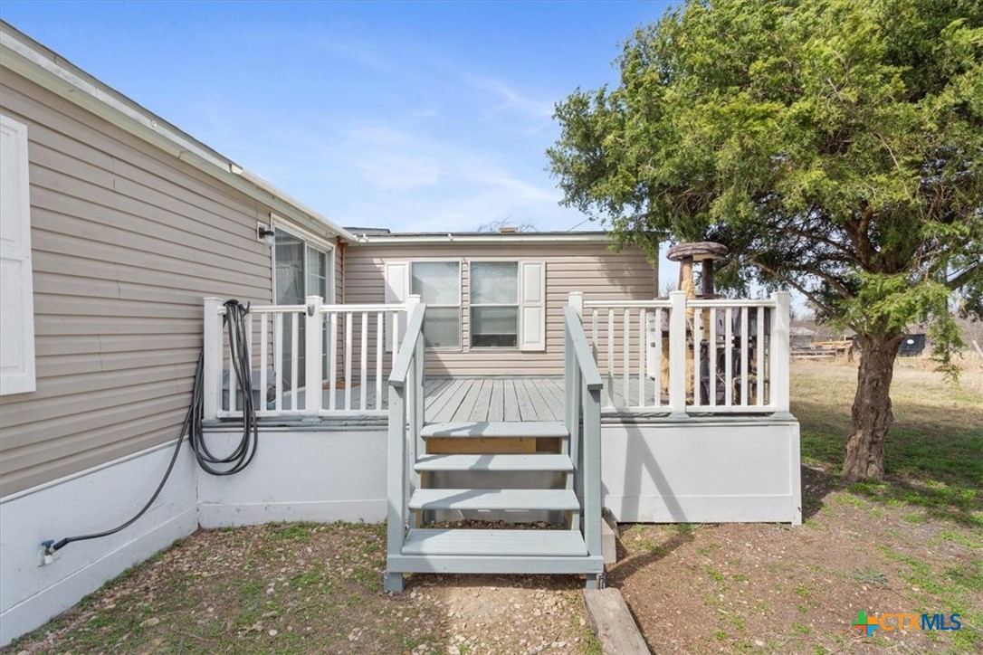 216 Moore Street Rogers, TX 76569 - Photo 24 of 29 a view of outdoor space with deck and a garden