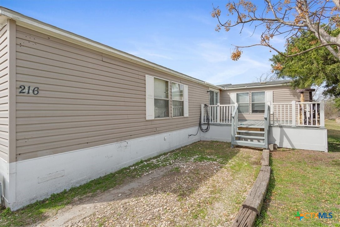216 Moore Street Rogers, TX 76569 - Photo 25 of 29 a view of a house with a backyard and a tree
