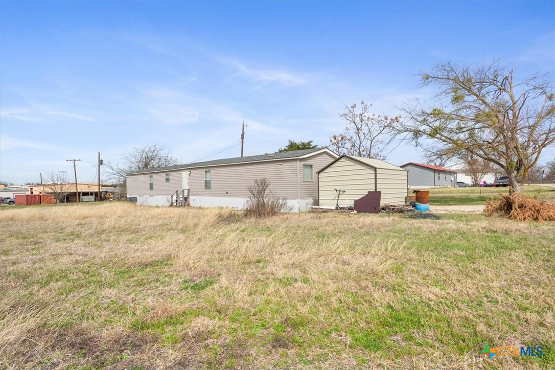 216 Moore Street Rogers, TX 76569 - Photo 27 of 29 a view of a house with snow on the road