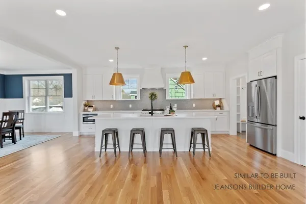 a kitchen with counter space dining table and chairs