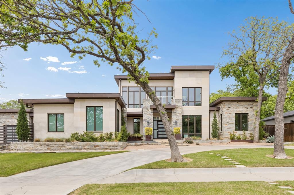 548 Oak Grove Lane Coppell, TX 75019 - Photo 1 of 36 a front view of a house with a yard and garage