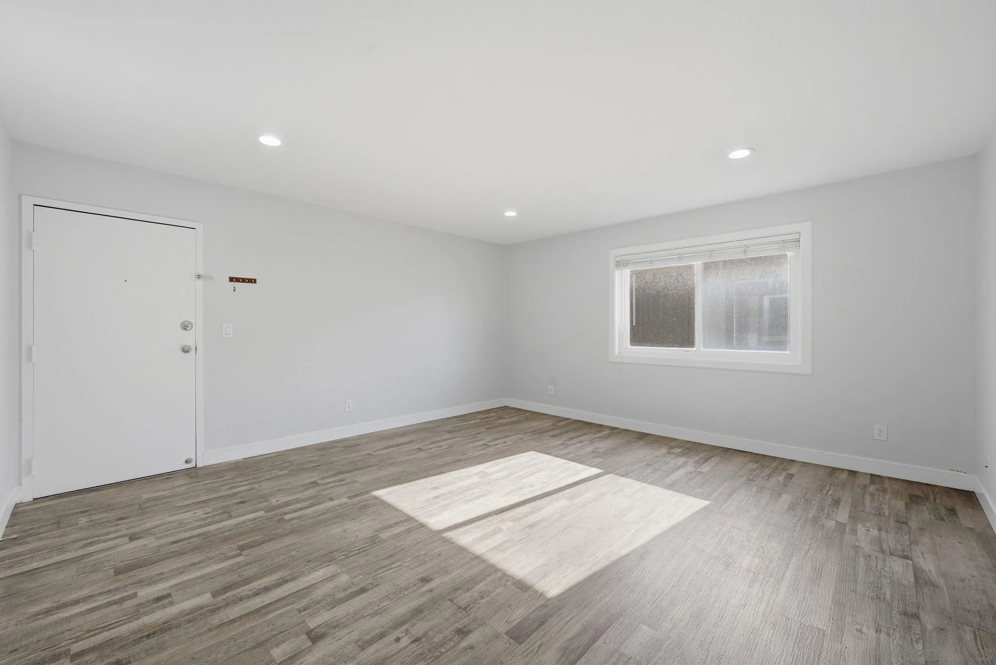 293 Sycamore Road, Unit 15 San Ysidro, CA 92173 - Photo 13 of 25 an empty room with wooden floor and windows