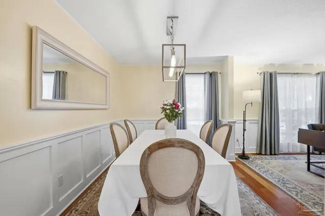 a dining room with furniture and wooden floor