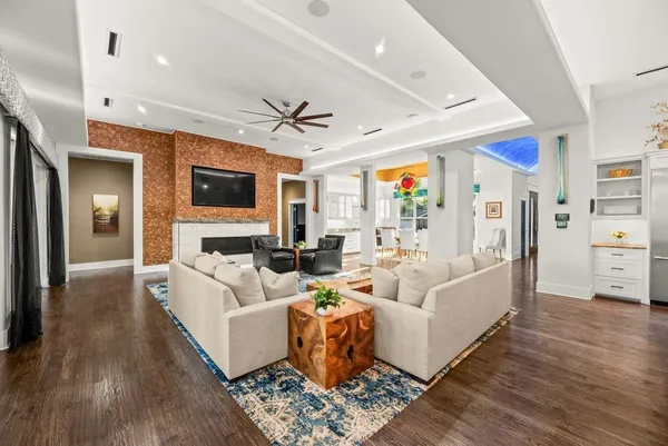 a living room with furniture fireplace and a flat screen tv