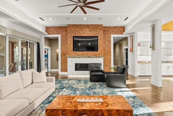 a living room with furniture a fireplace and a flat screen tv