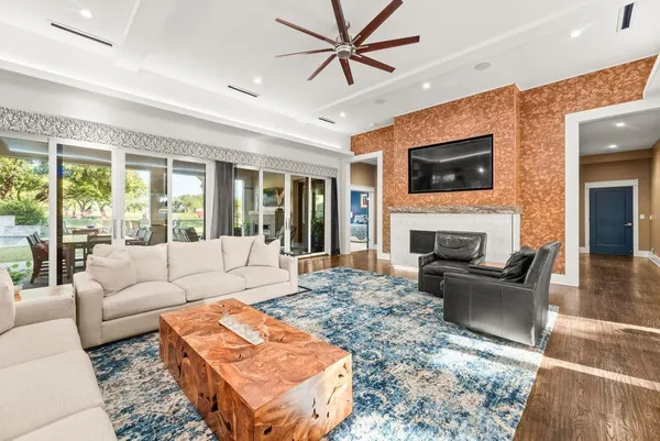 a living room with furniture a flat screen tv and a fireplace