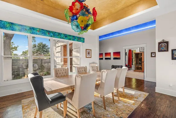 a view of a dining room with furniture wooden floor and chandelier