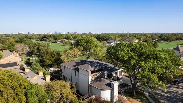 a view of a city with lush green forest