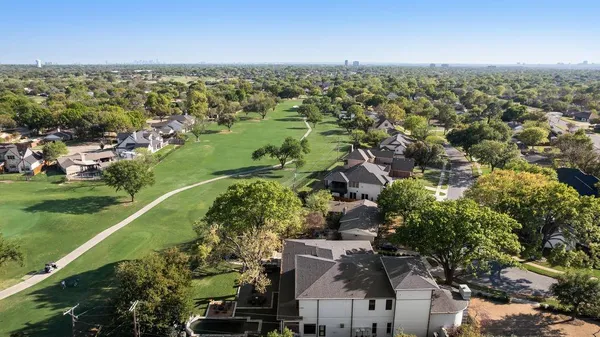 an aerial view of residential houses with outdoor space and river