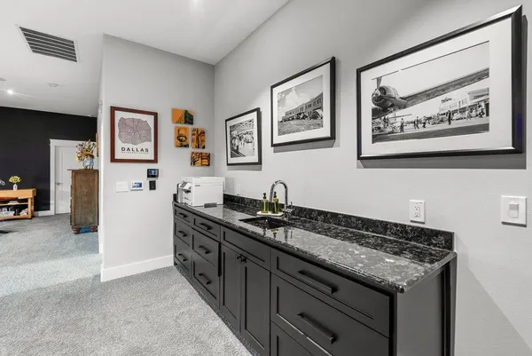 a spacious bathroom with a granite countertop sink a toilet a mirror and shower