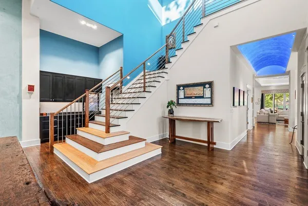 a view of entryway and hall with wooden floor