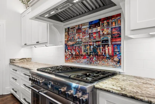 a stove top oven sitting inside of a kitchen