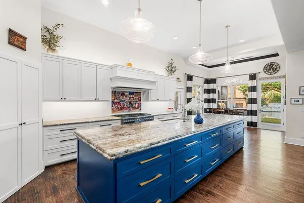 a kitchen with a stove and a wooden floor