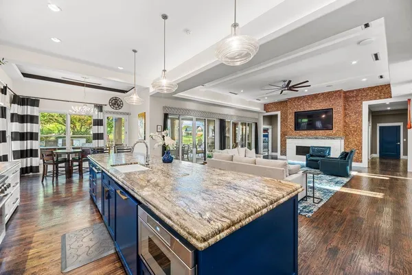 a view of kitchen island dining room wooden floor and living room