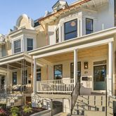 a living room with furniture and a view of kitchen