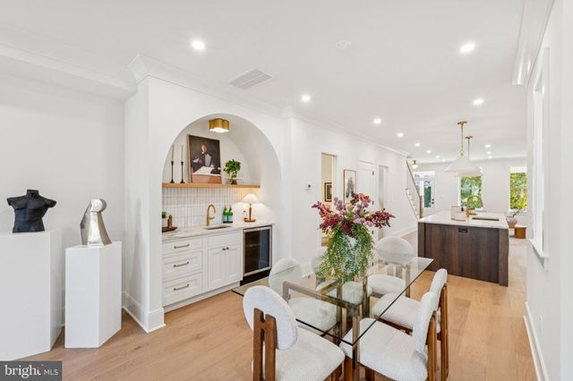 a dining room with furniture and a chandelier