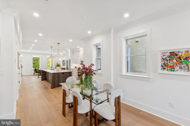 a living room with furniture kitchen view and a table