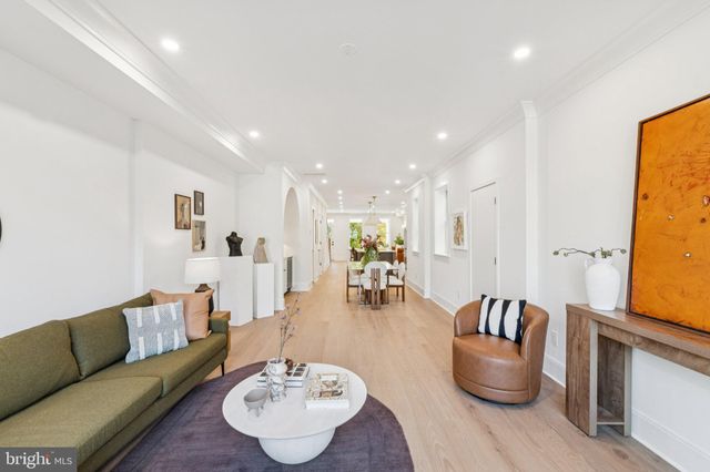 a bedroom with a bed and large windows