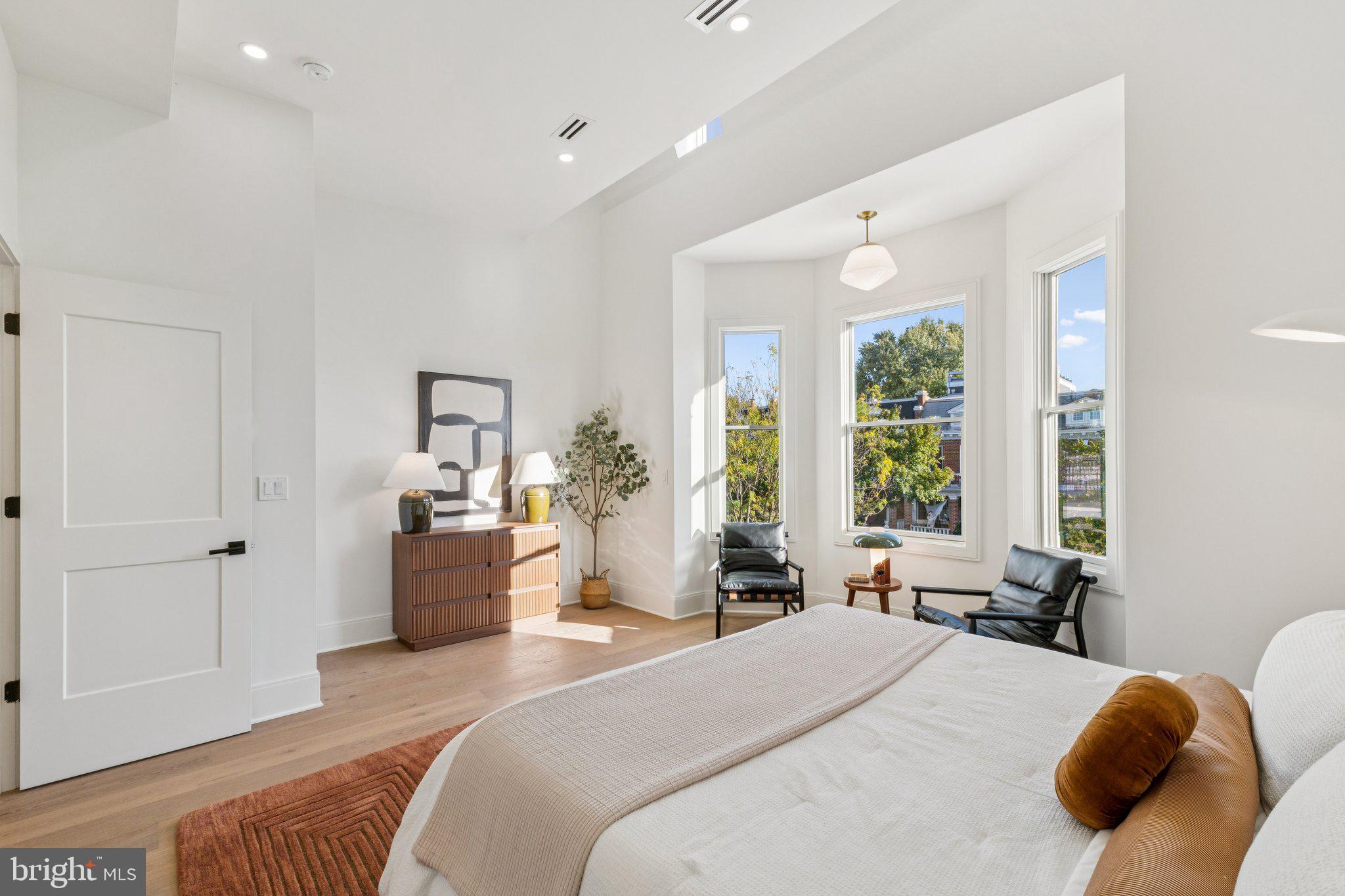 21 W Street Northwest Washington, DC 20001 - Photo 22 of 56 a bedroom with a bed and large windows
