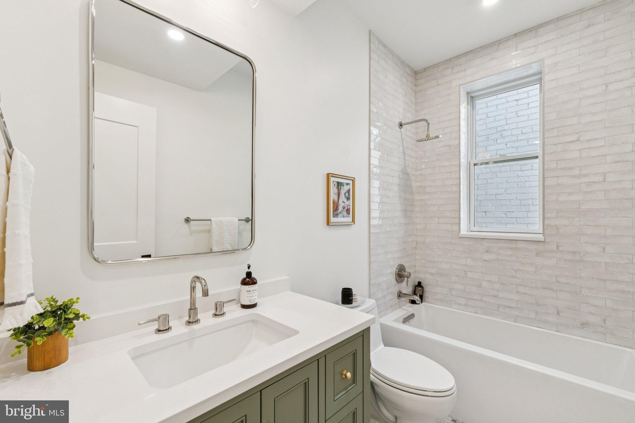 21 W Street Northwest Washington, DC 20001 - Photo 32 of 56 a bathroom with a sink toilet tub and shower