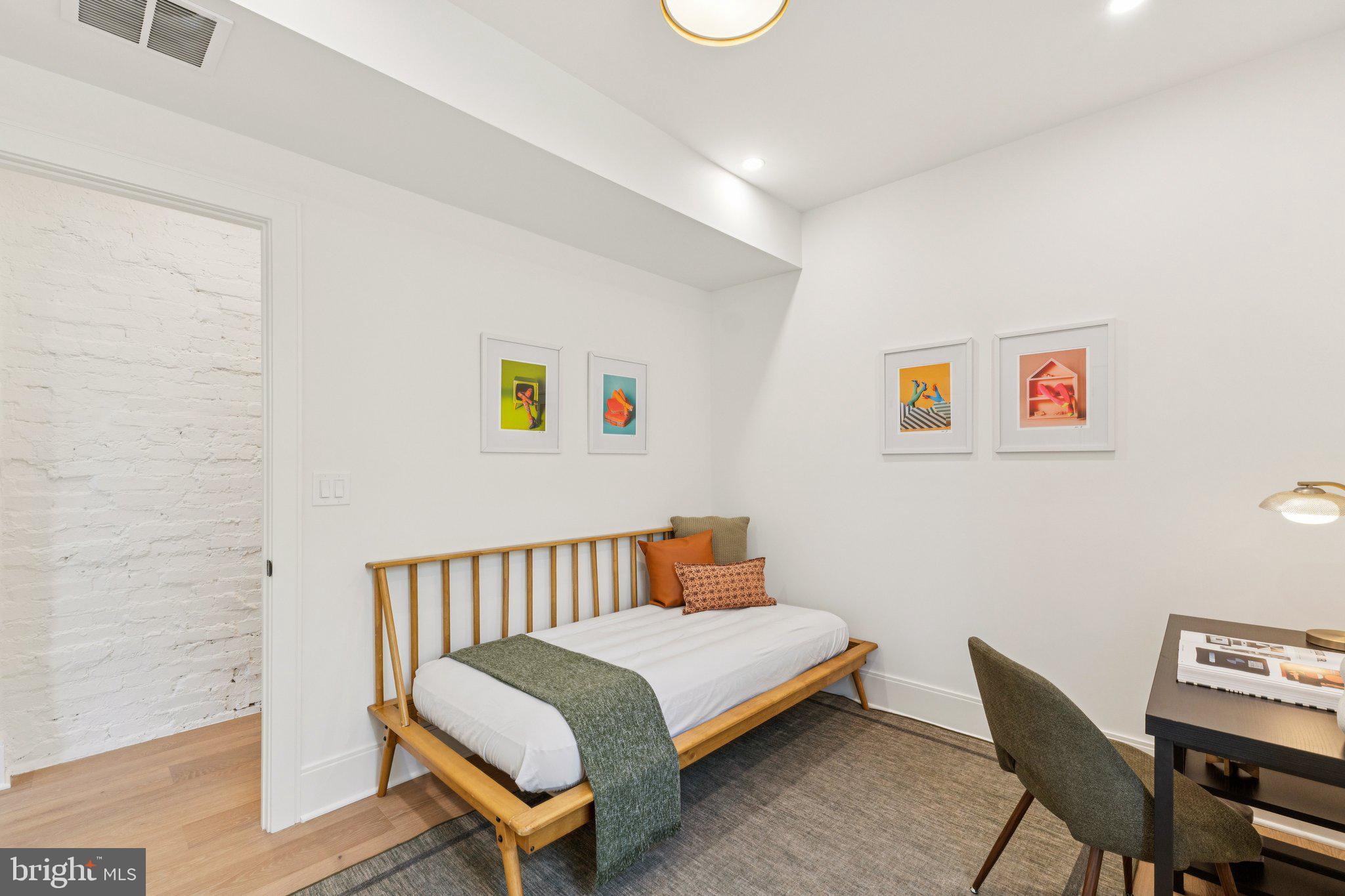 21 W Street Northwest Washington, DC 20001 - Photo 33 of 56 a bedroom with a bed and a chair