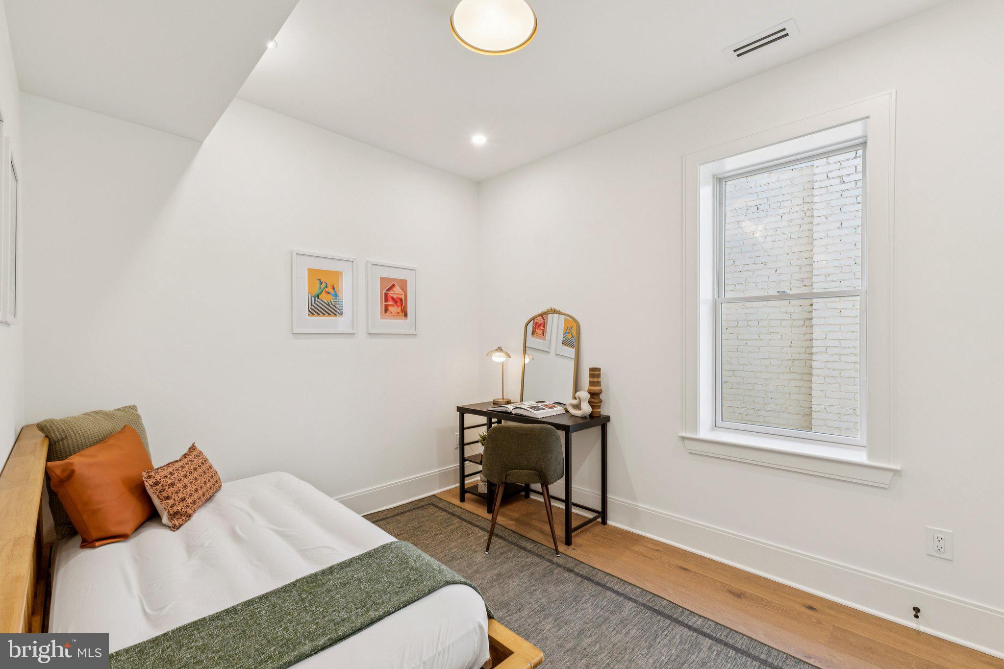 21 W Street Northwest Washington, DC 20001 - Photo 34 of 56 a bedroom with a bed and a window