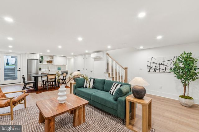 a kitchen with a dining table chairs and refrigerator